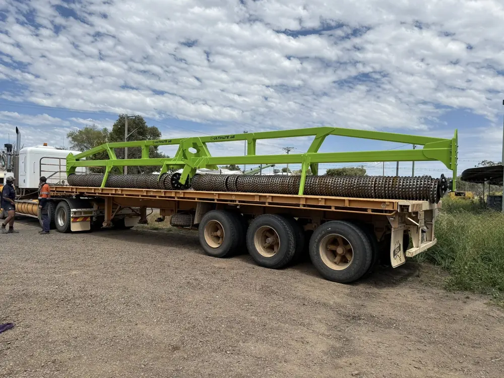 Completed Ultimate Ag cultipacker loaded on a flatbed semi trailer ready for delivery