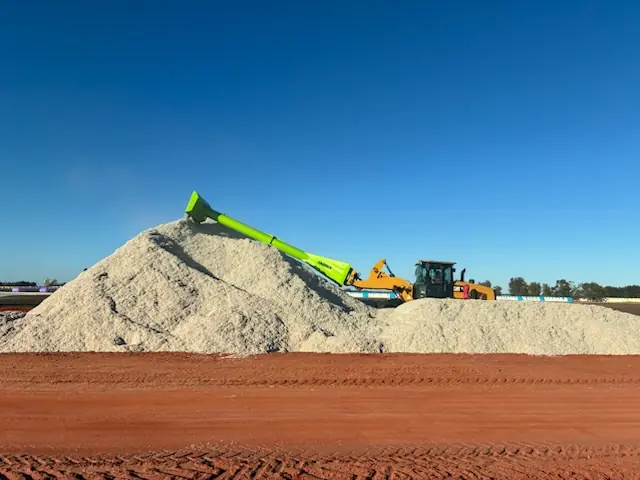 Wheel loader fitted with an Ultimate Ag pusher blade working a stockpile